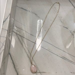 long gold necklace with stone pendant